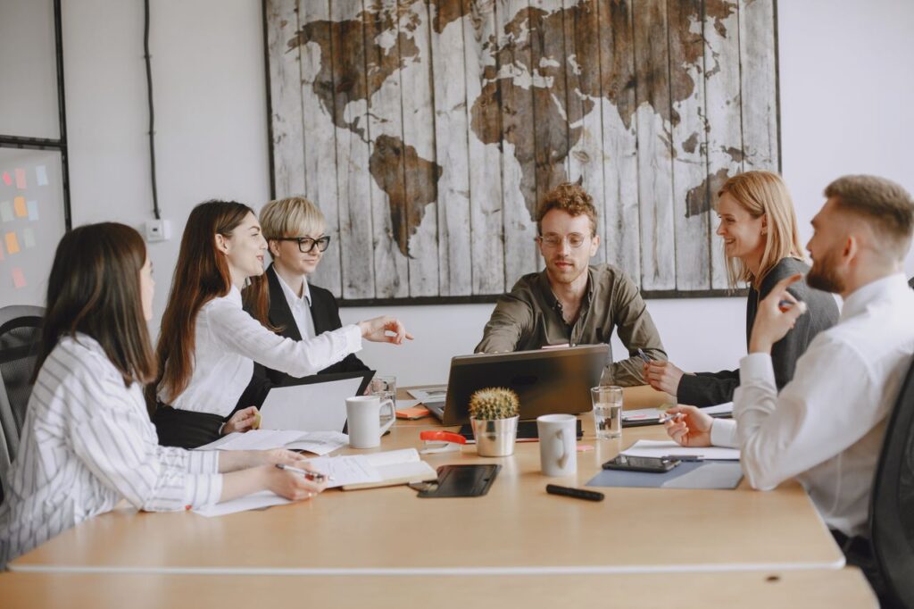 Business team discussing a project around a table indoors.